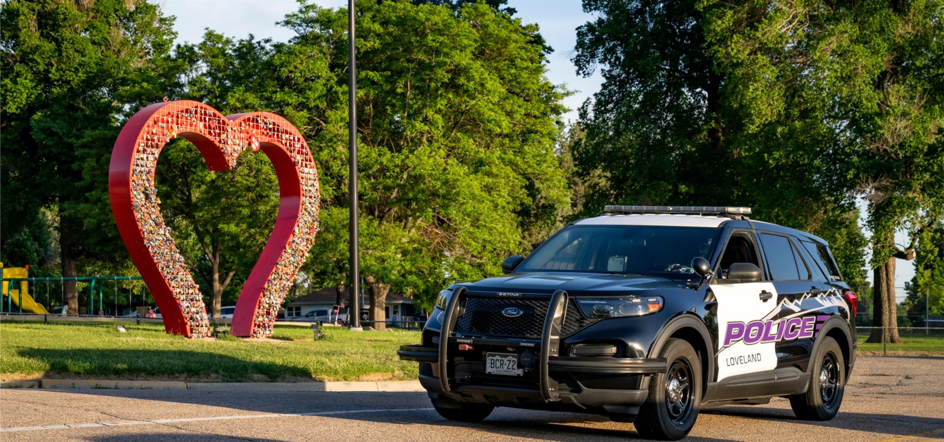 police car parked by Heart Sculpture