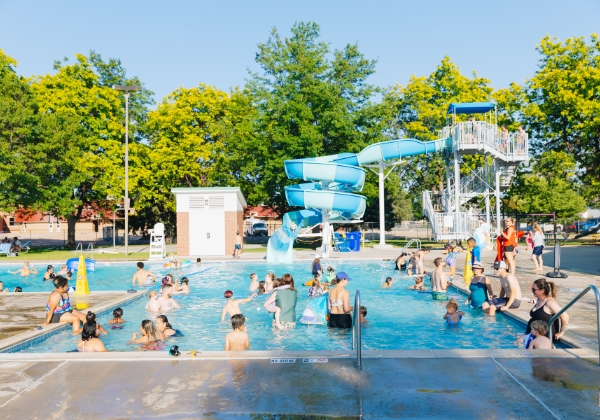 Water slide and people in the Winona Outdoor Pool.