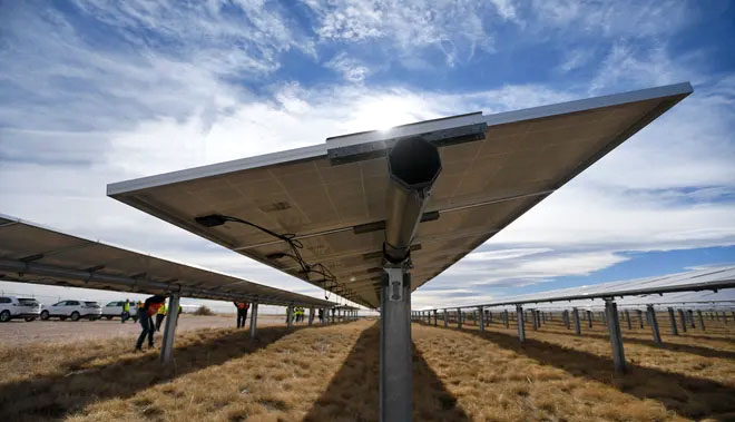 Close view of the underside of a solar panel with blue sky above
