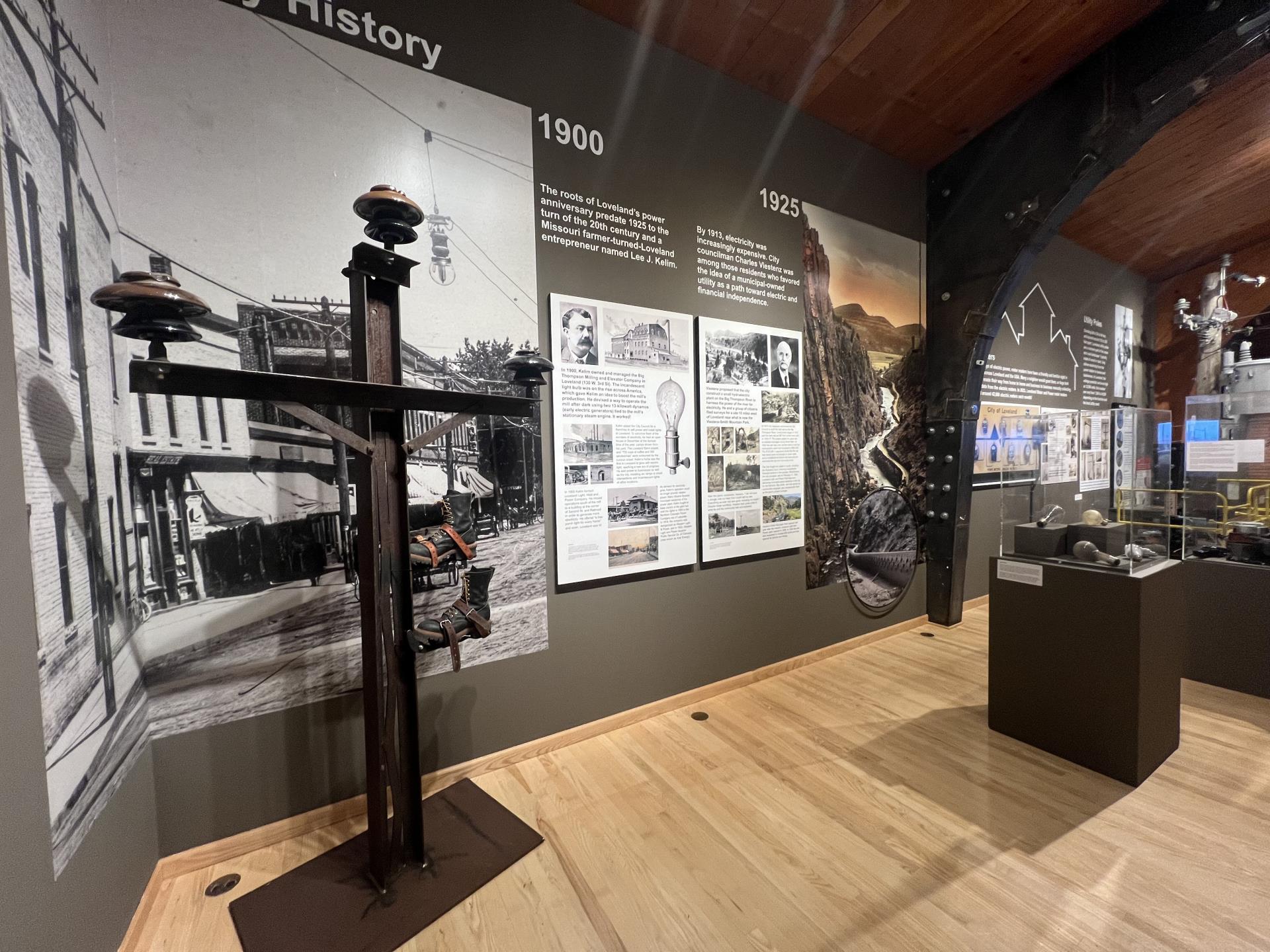 Partial gallery view to the print panels and multimedia materials featured in the 100 Years of Power exhibit, Loveland Museum, July-October 2025.